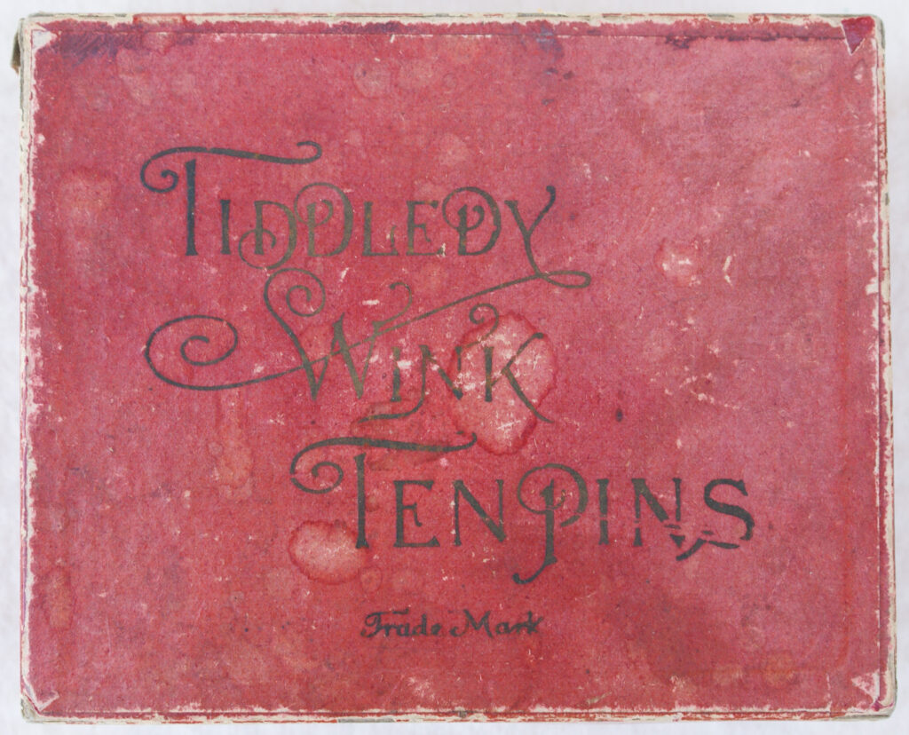 Tucker Tw ID • UNK-010v2c1 — AGPI ID • G-30137c1 — publisher • (unknown) — title • TIDDLEDY WINK TEN PINS — notes • Dark red cardboard cover without leatherette texture.